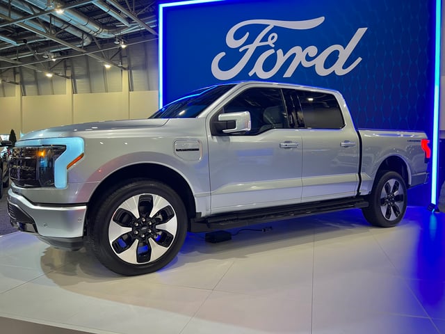 A picture of a grey Ford F-150 Lightning at a promotional event.