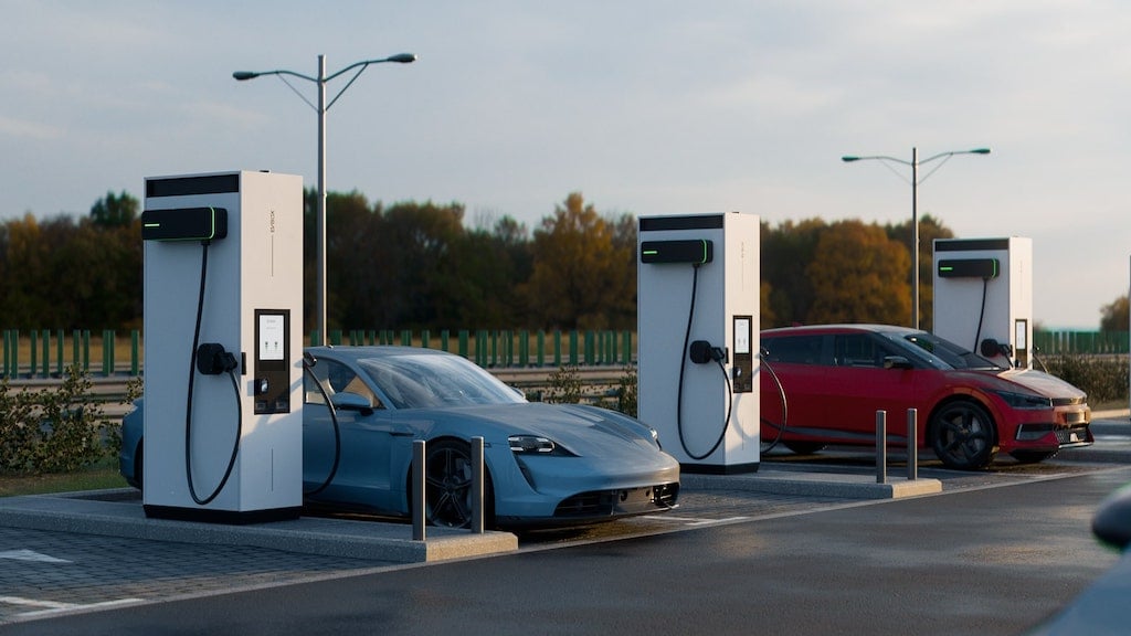 Two cars are being charged by EVBox Troniq High Power fast charging stations.