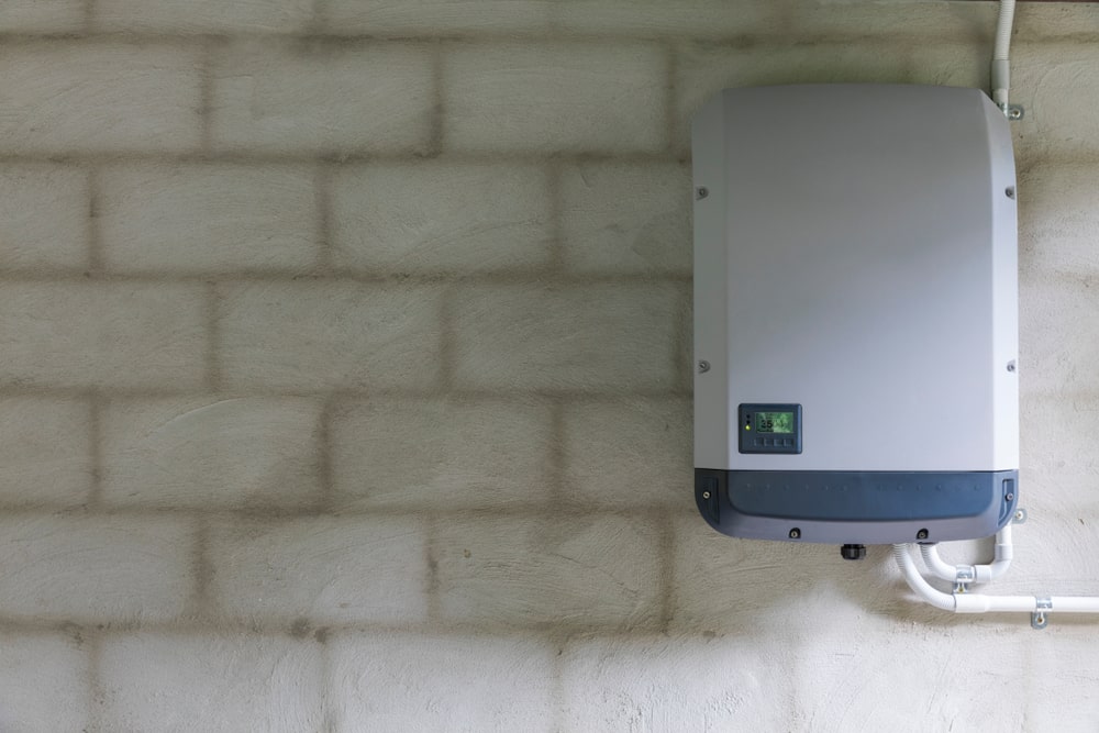 A string inverter mounted to a wall.