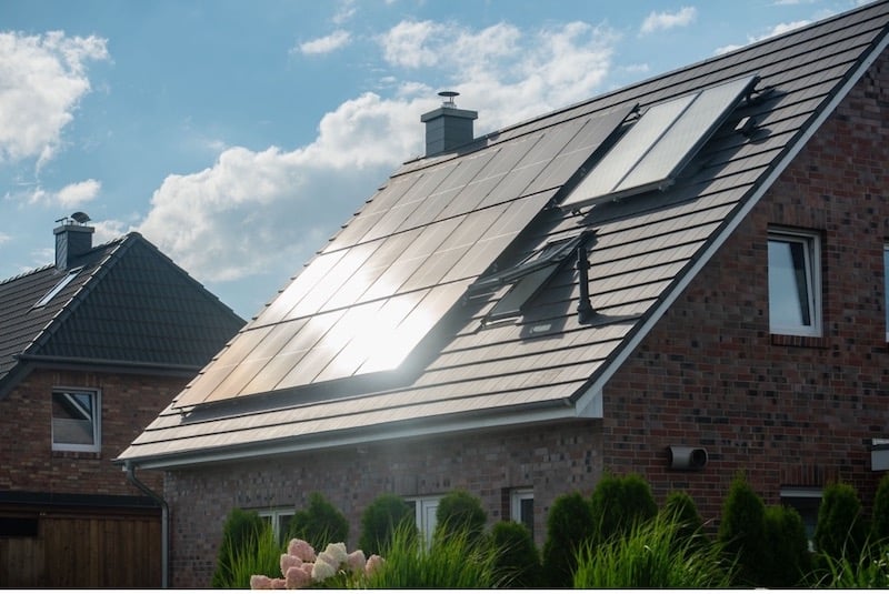 Solar panels are absorbing sunlight on the roof of a home.