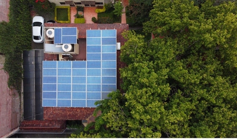 An aerial shot of a rooftop filled with solar panels.