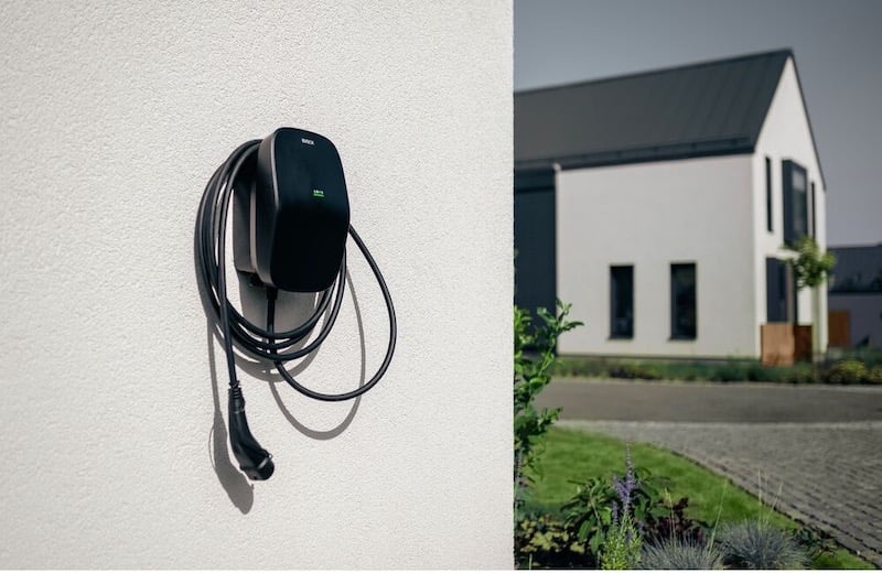 A EVBox Livo home charging station is installed on the wall.