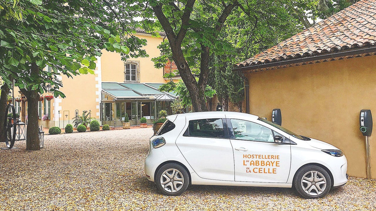 A French hotel with an EVBox charging station in the car park.