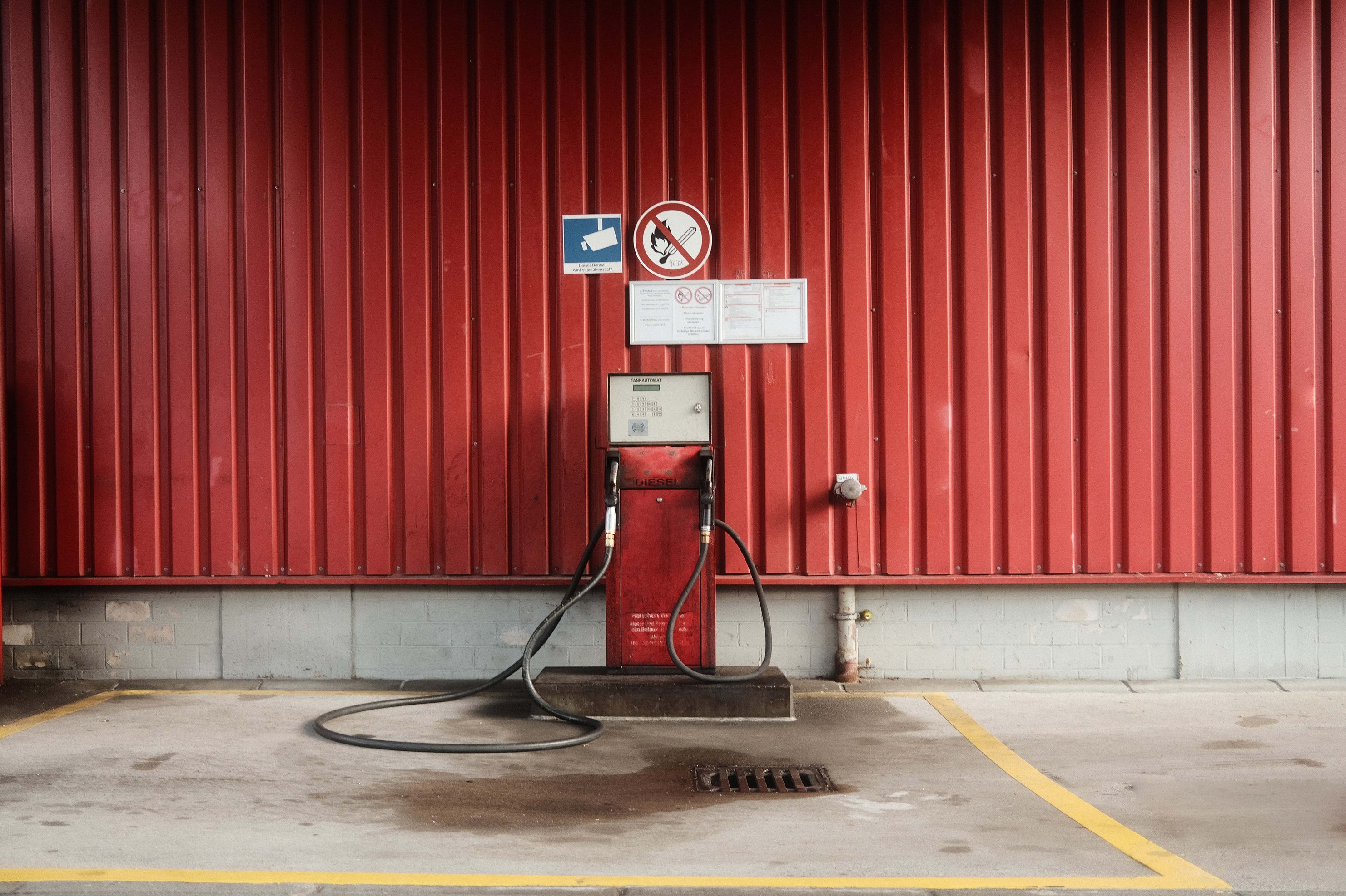 Red gas station with two nozzles.