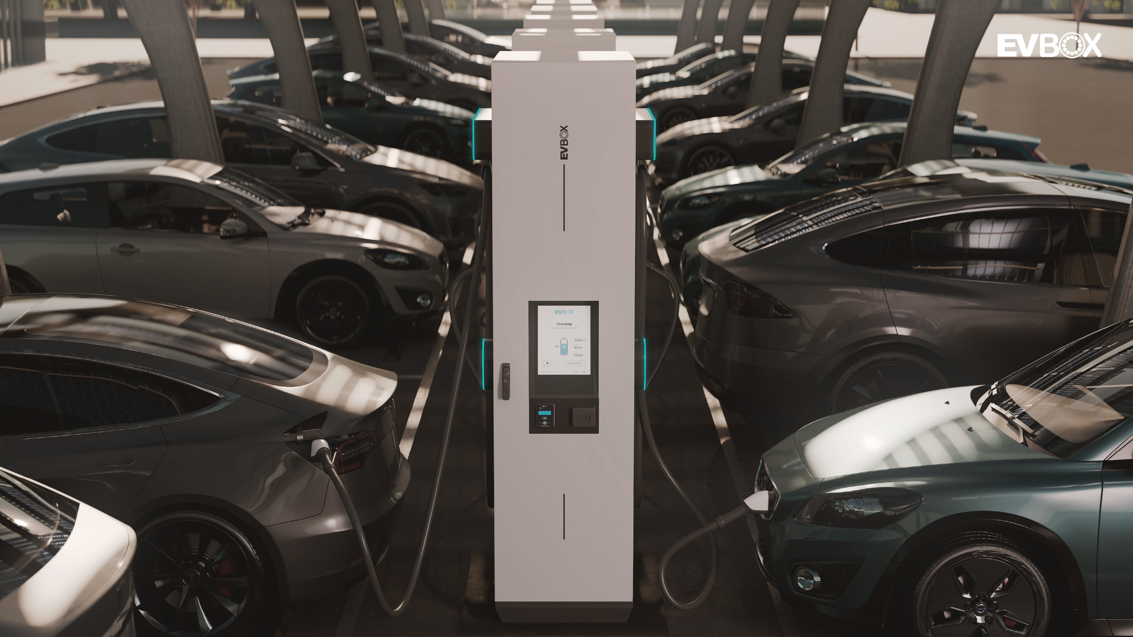 A car park with multiple DC fast charging stations centered in the middle of two rows filled with electric vehicles.