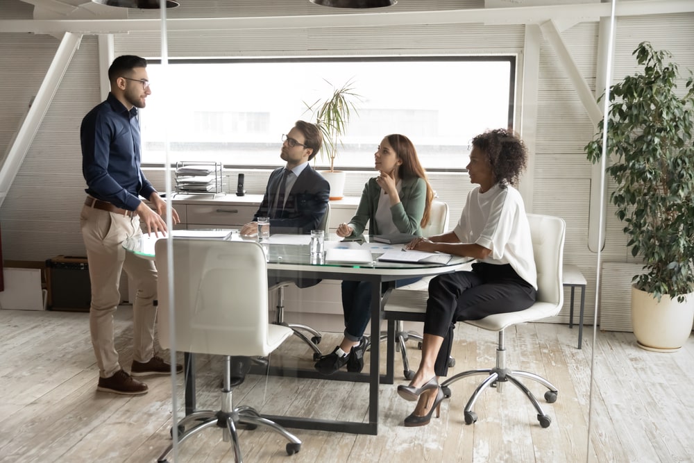 Four people having a business meeting around a table in an office