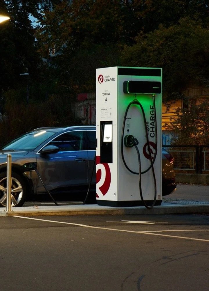 An EV charges at a DC fast-charging station