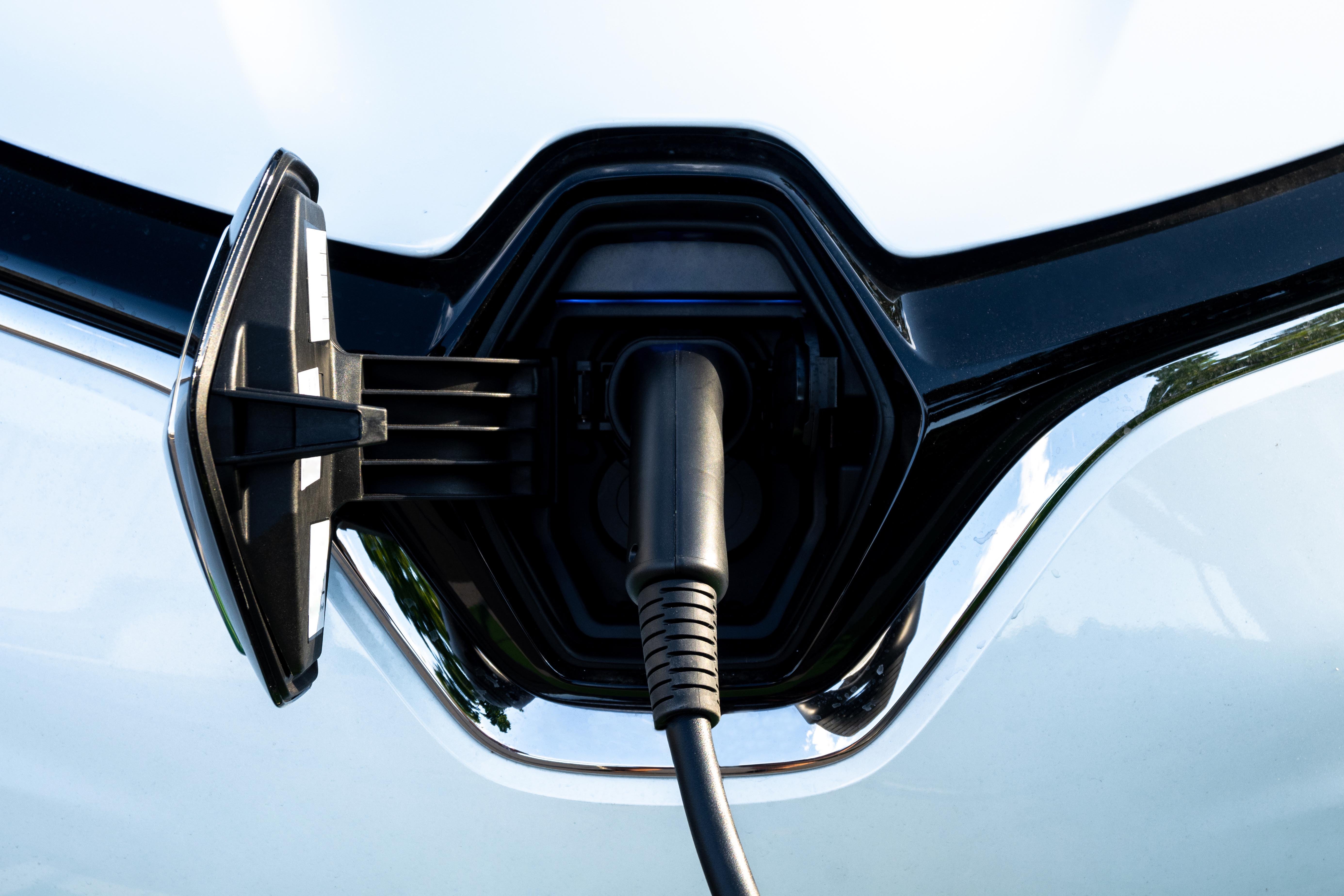 car-recharges-its-electric-batteries-inside-private-garage-with-its-own-charging-station-detail-connected-plug
