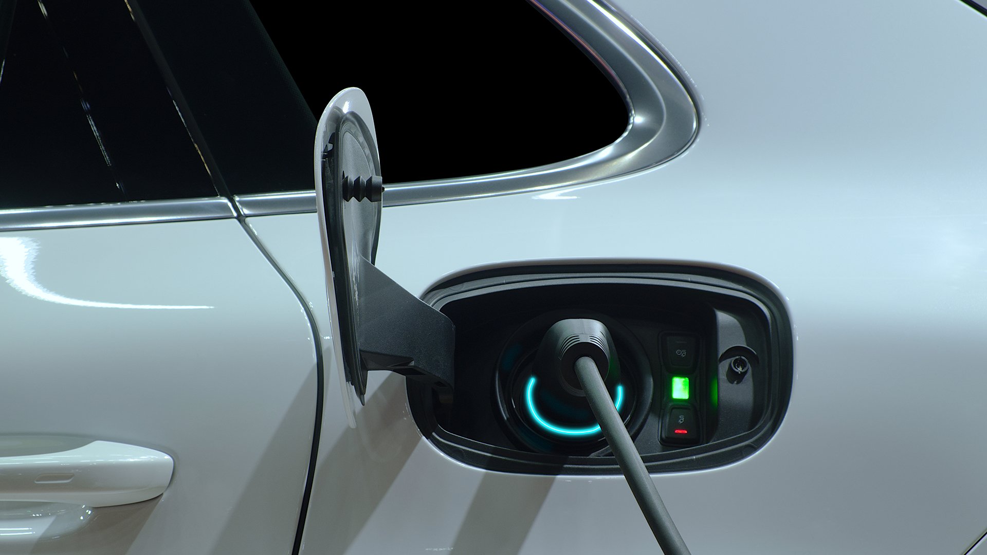 An electric vehicle charging via a charging cable that is equipped with modern lighting.