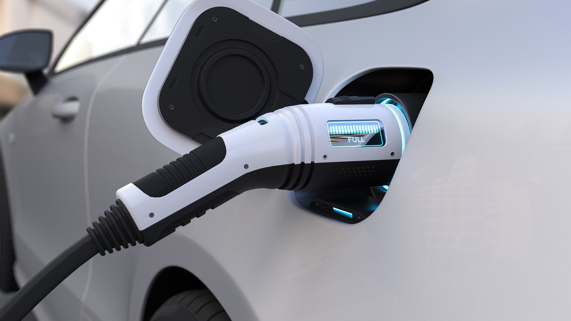 An electric vehicle charging cable plugged into a vehicle,  the socket is equipped with a LED screen that indicates the current status of the charge. In this case, the vehicle's battery is fully charged. 
