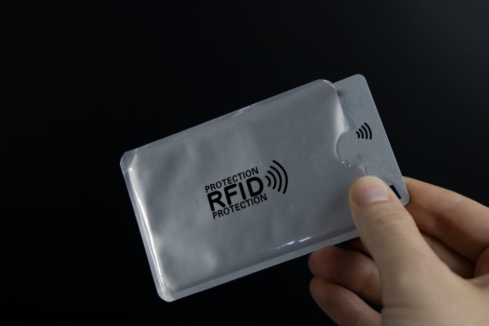 A hand holding an RFID card.